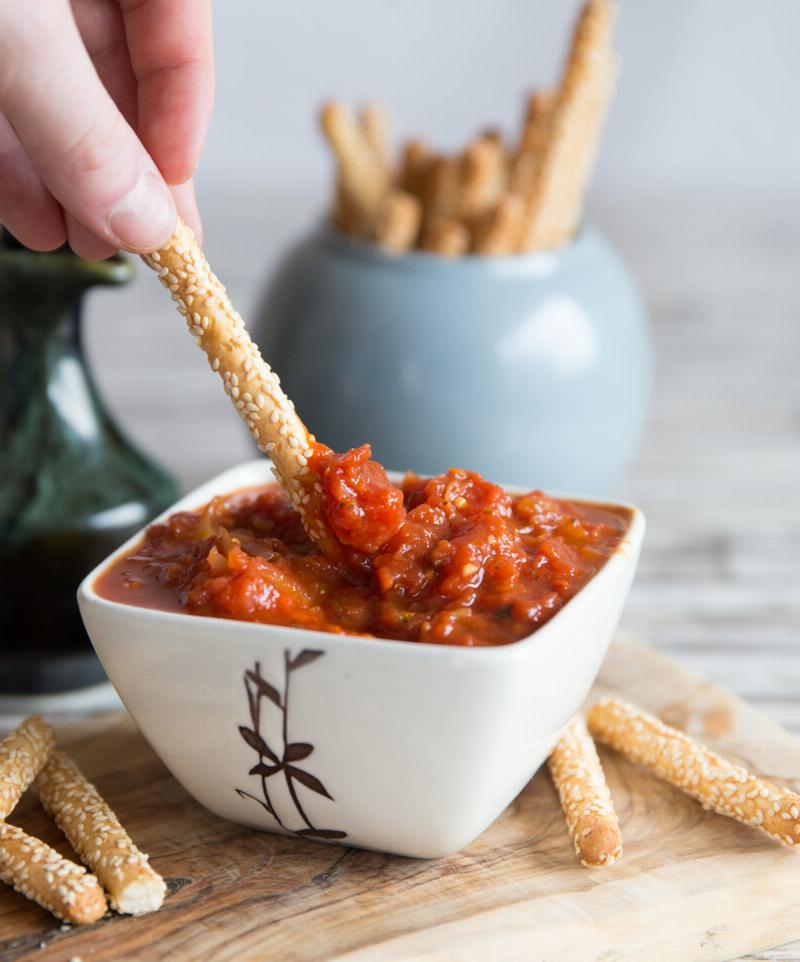 Freshly baked garlic butter bread knots with marinara sauce for dipping