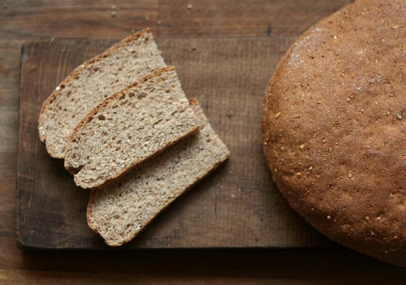 Golden brown oat bread loaf fresh from the oven