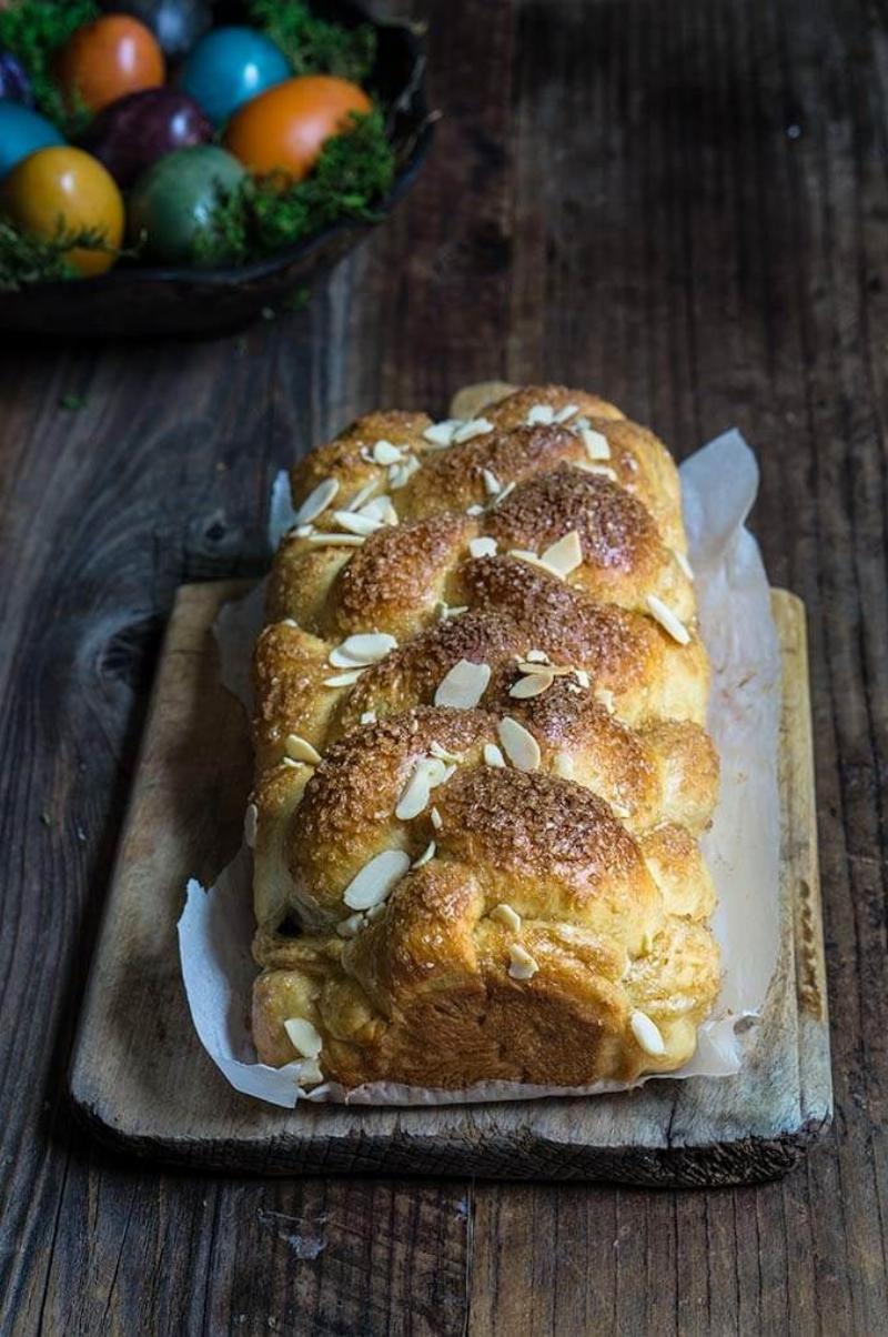 A Loaf of Bread with Seeds and Nuts on a Wooden Board