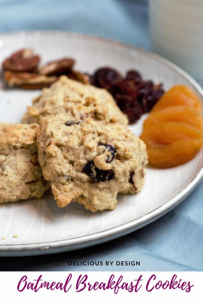 A plate of chewy oatmeal raisin cookies with a glass of milk.