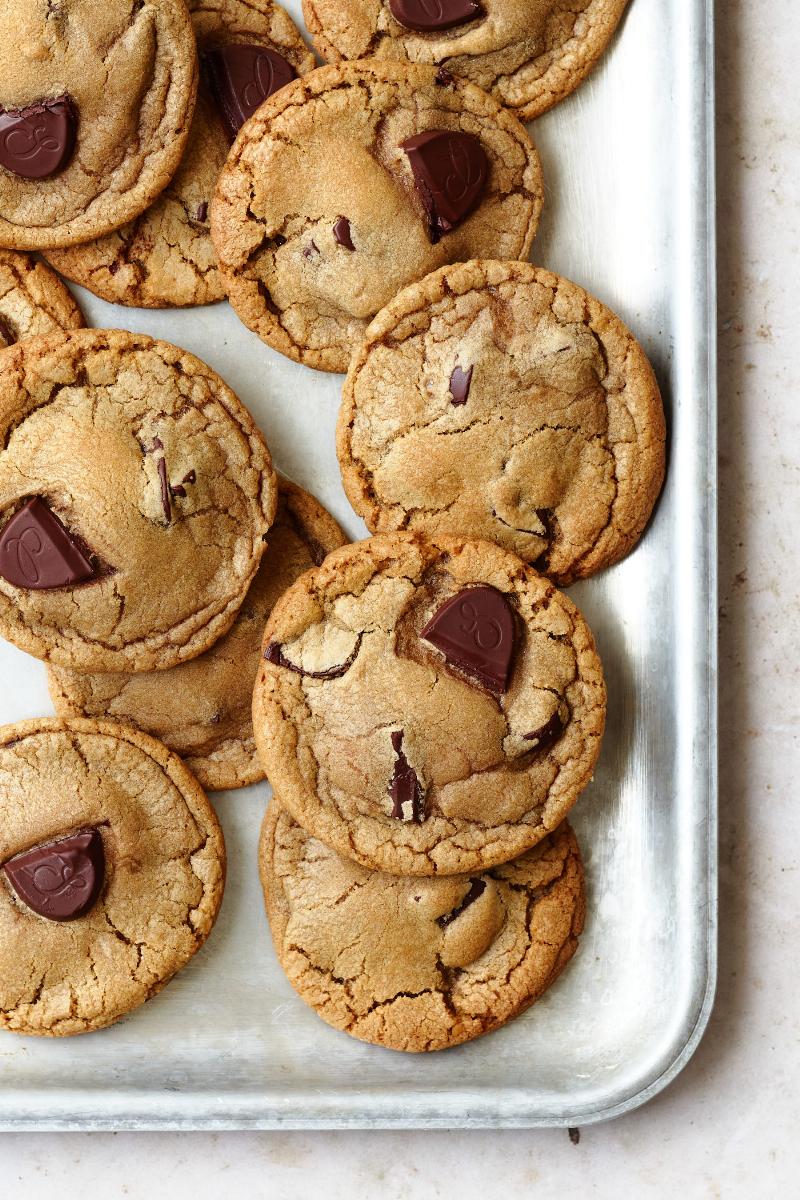 Dark chocolate chips being folded into cookie dough