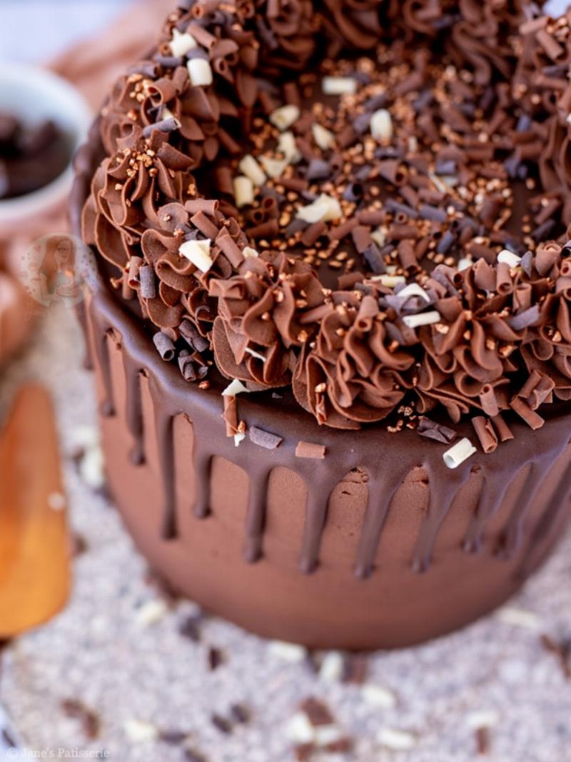 Dark chocolate ganache dripping down a layered cake