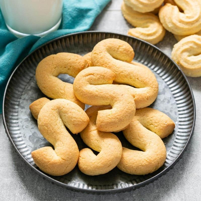 Cookies arranged on a baking sheet lined with parchment paper before freezing