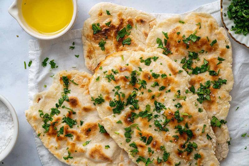 Cooking gluten free naan on a cast iron skillet