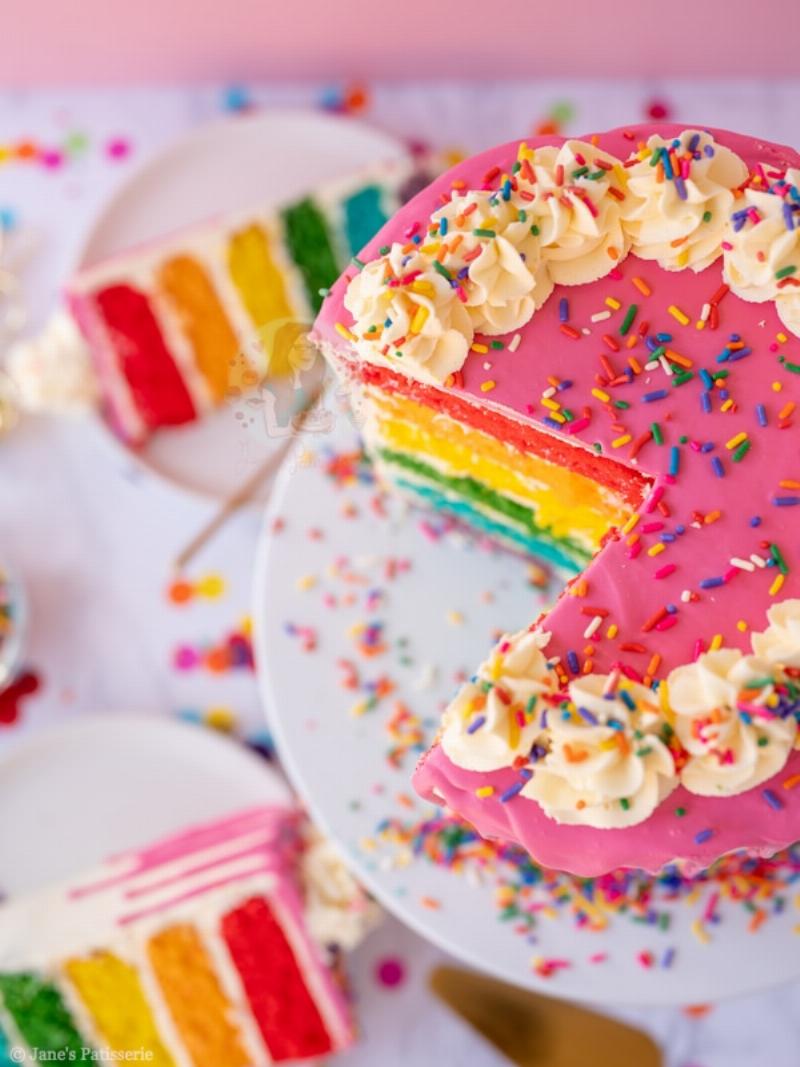 Frosting Rainbow Cake Layers with White Buttercream