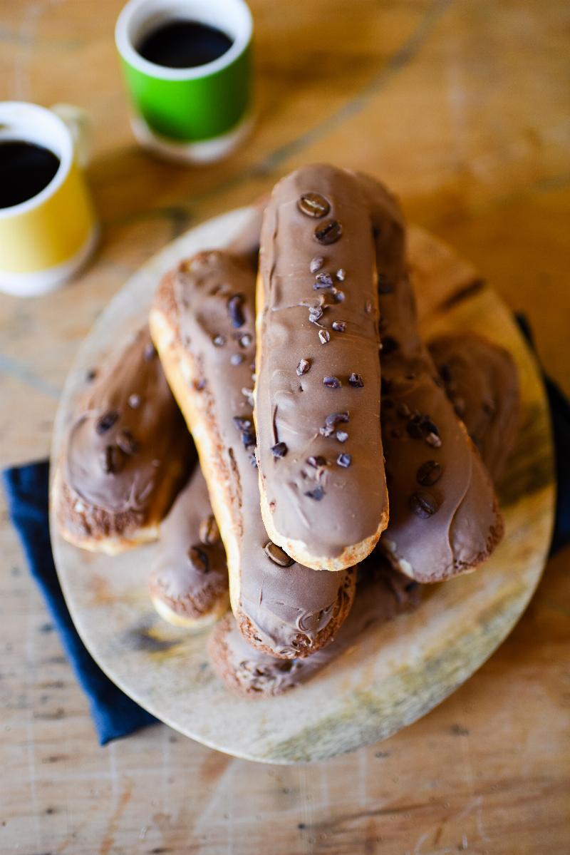 Gluten-free eclairs with vanilla, chocolate raspberry, and coffee cream fillings.