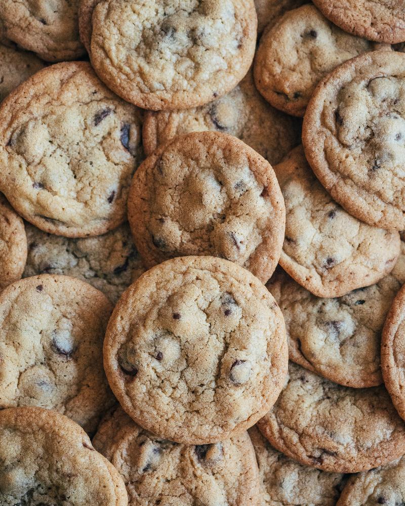 Perfectly baked golden brown and crispy cookies cooling on a wire rack.