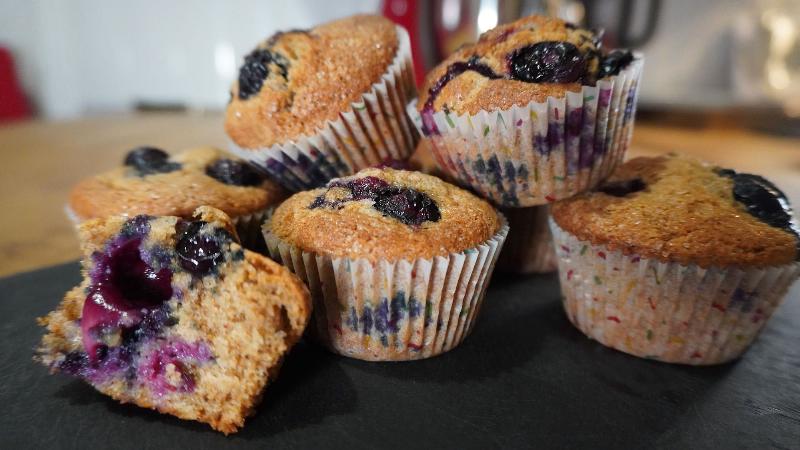 Preparing a muffin tin by greasing and flouring