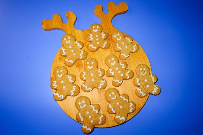 Keto Gingerbread Cookies Baking: Festive shapes on a parchment-lined baking sheet, ready for the oven.