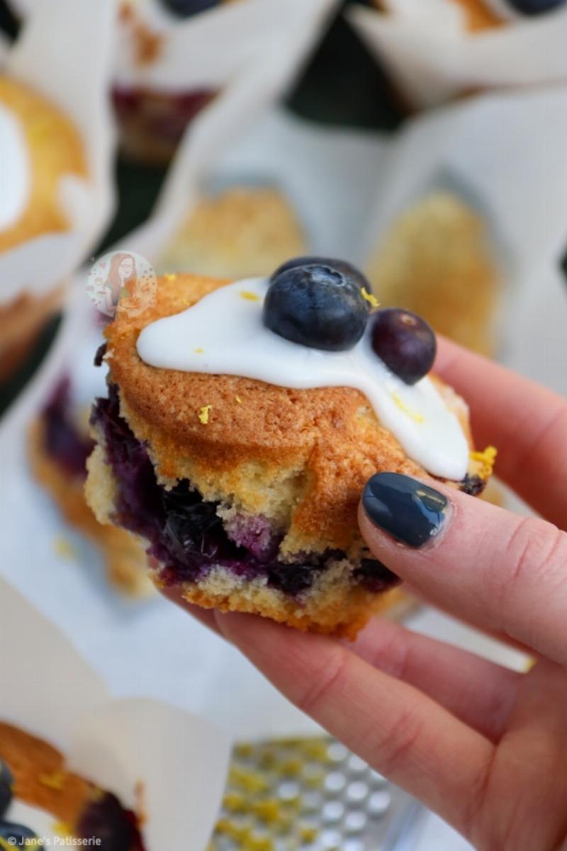 Zesting a lemon and preparing fresh blueberries for lemon blueberry muffins