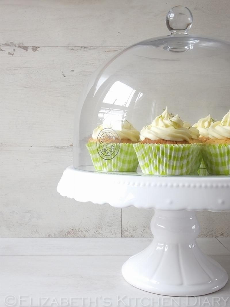 Piping lime cupcake frosting onto cupcakes