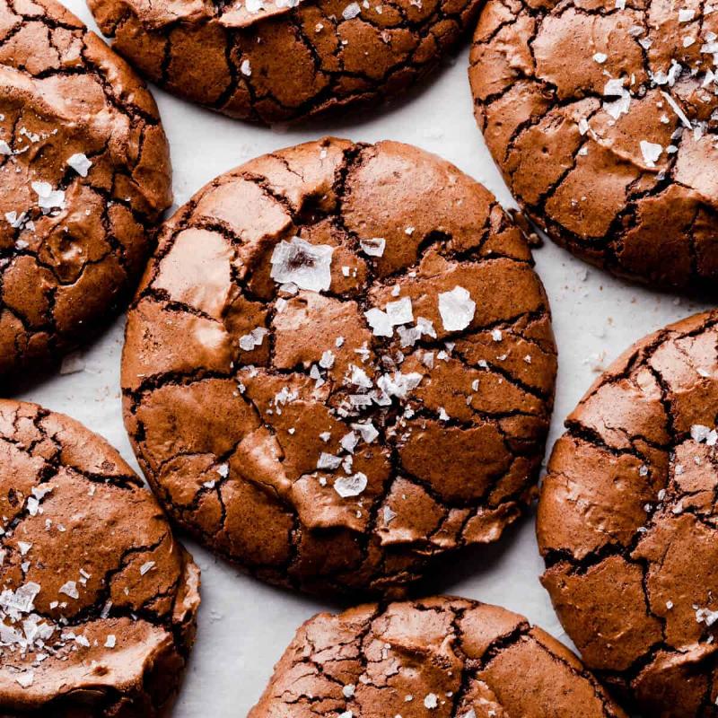 Close-up of a perfectly crinkled cookie, showcasing the cracked surface and fudgy interior.