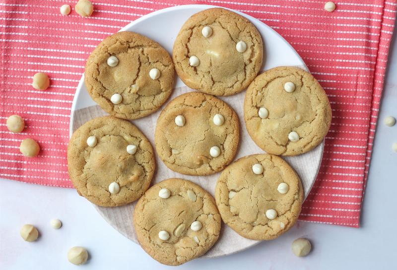 Golden-brown macadamia nut cookies cooling on a wire rack