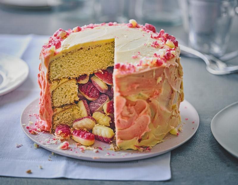 Two perfectly golden layers of yellow cake cooling on a wire rack