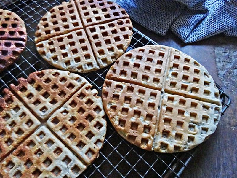 Pouring Pizzelle Batter: Carefully pouring the batter onto a hot pizzelle iron.