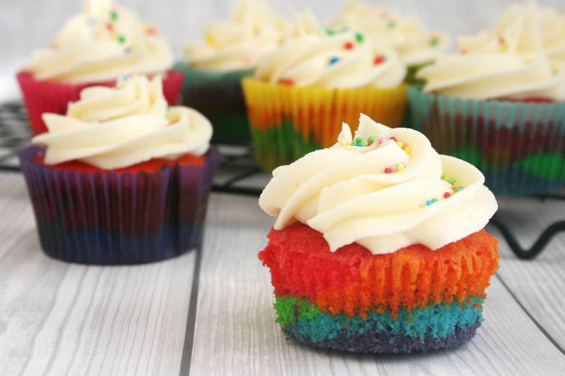 Colorful bowls of rainbow cupcake batter ready for baking