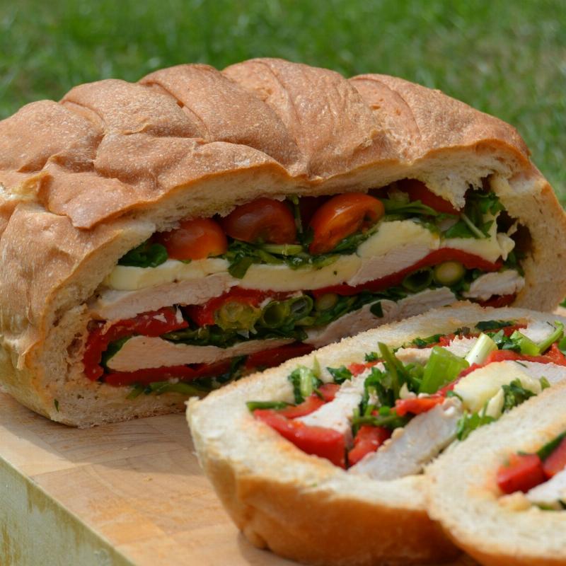 Serrated knife slicing through a loaf of bread