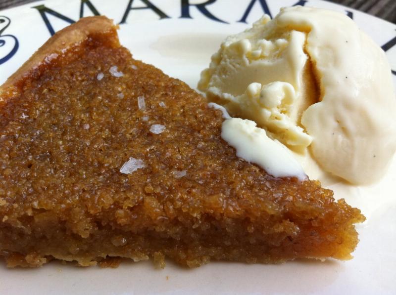 A delicious slice of bread pudding served with a scoop of vanilla ice cream