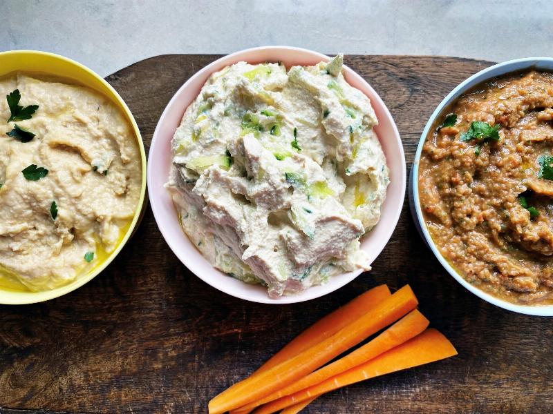 Serving unleavened bread with various dips like hummus and tzatziki.