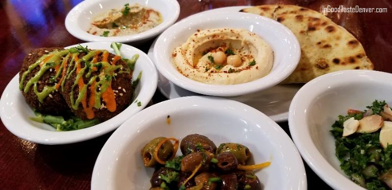 An assortment of flatbreads from around the world arranged on a rustic wooden table.