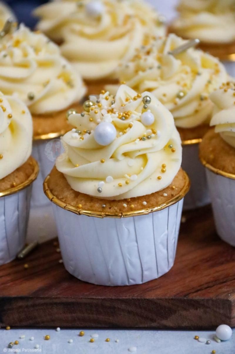 Various Frosting Flavors Piped on Vanilla Cupcakes