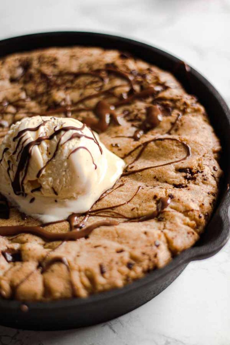 Vegan Chocolate Chip Cookies: Close-up of warm, gooey cookies on a baking sheet.