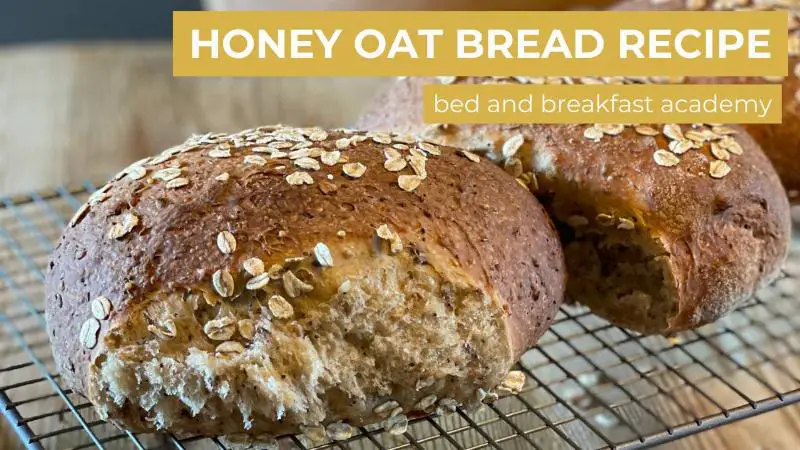 Freshly baked oat bread loaf on cooling rack