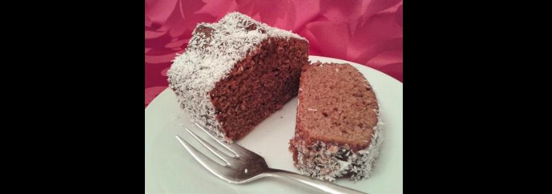 Freshly baked chocolate cake with sprinkles cooling on a wire rack.