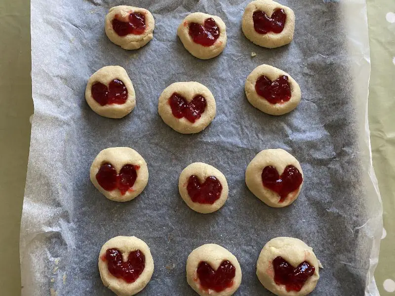 Enjoying fresh-baked jam-filled cookies with a glass of milk