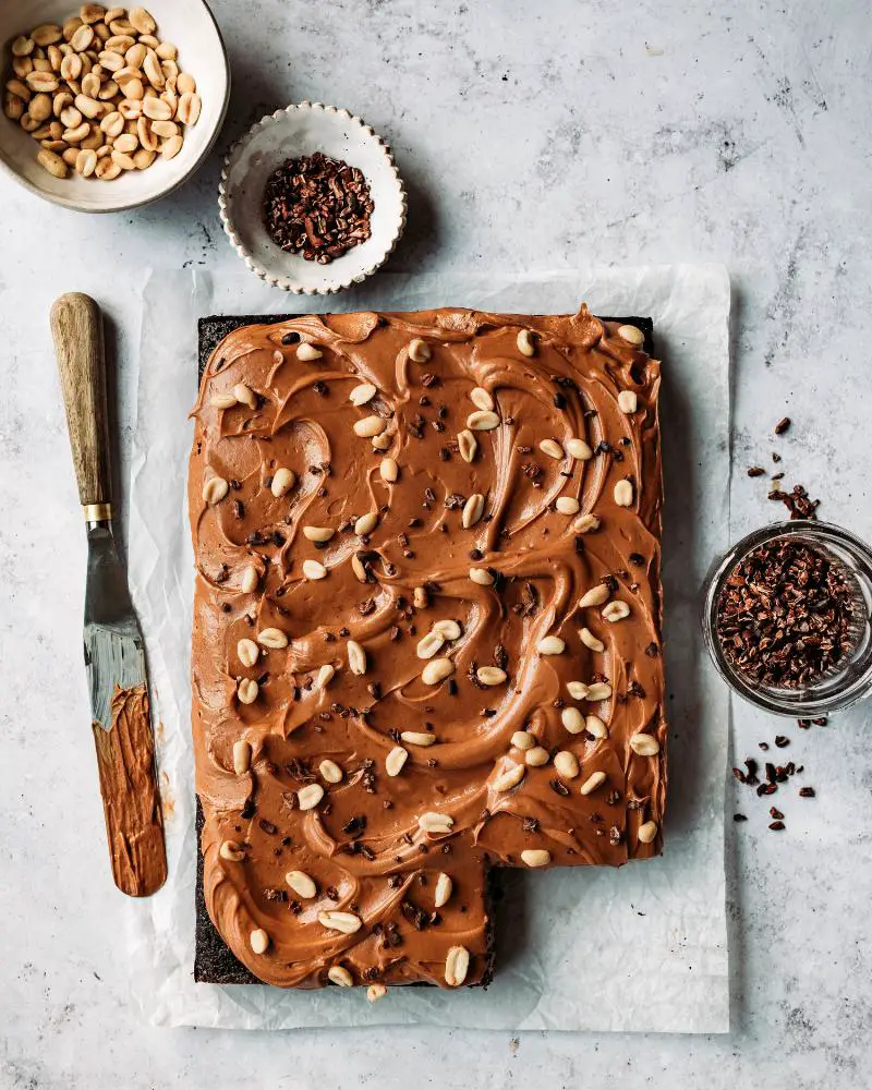 Caramel being drizzled over a chocolate cake