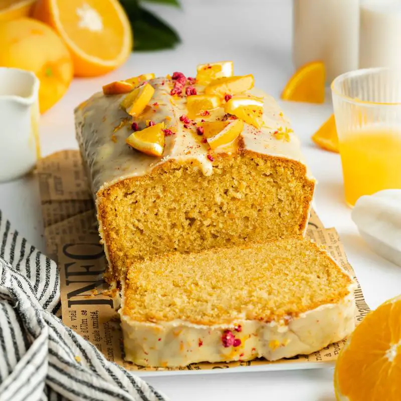 A view from above of a keto creamsicle swirl cake, showing the marbled vanilla and orange batter and covered in an orange-tinted citrus glaze.