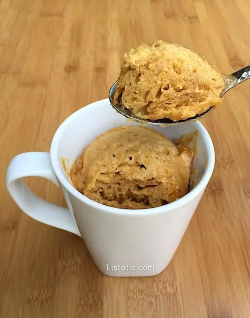 A rich keto peanut butter mug cake in a mug, possibly with a drizzle of peanut butter on top